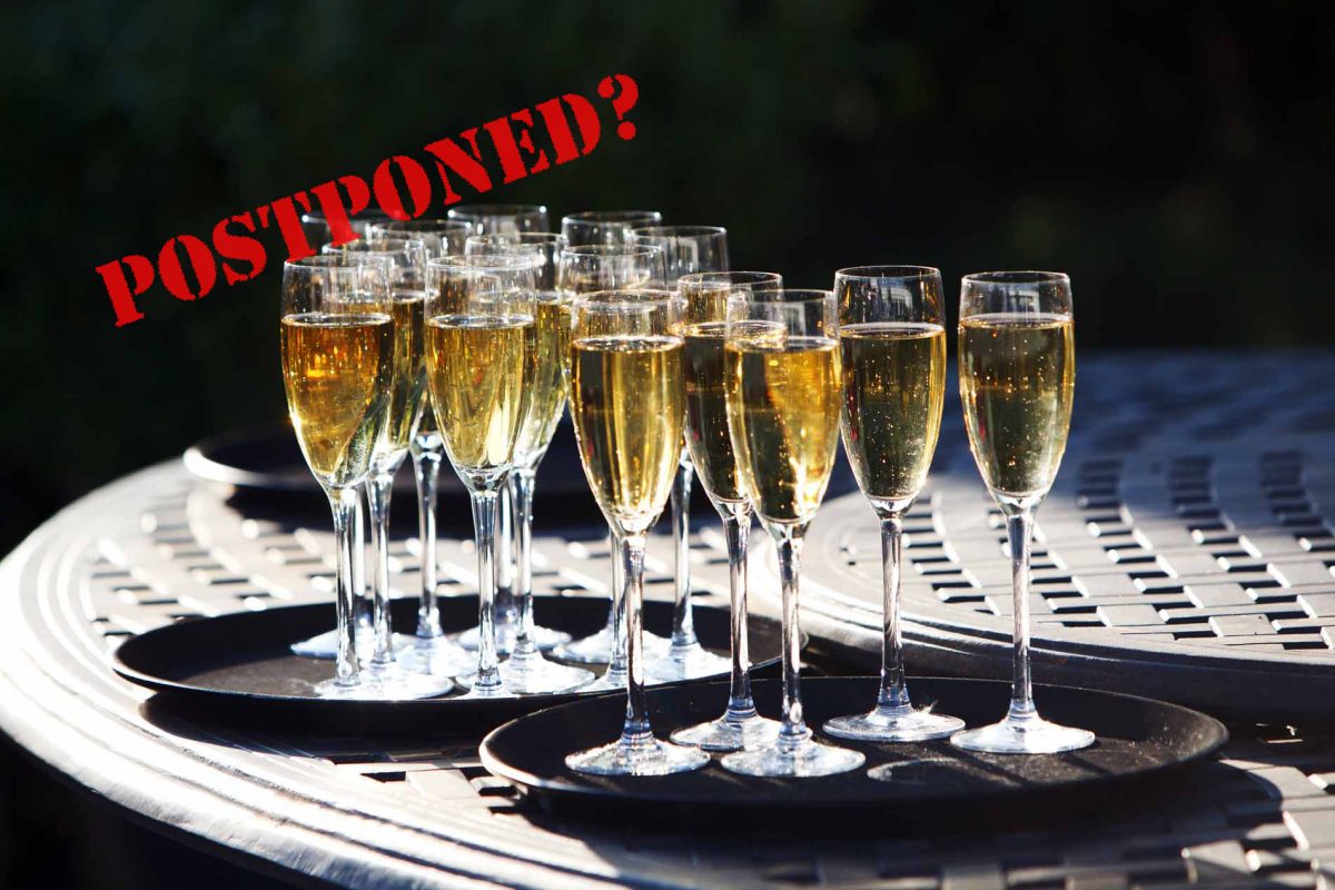 Pic shows champagne glasses overlaid with postponed rubber stamp text